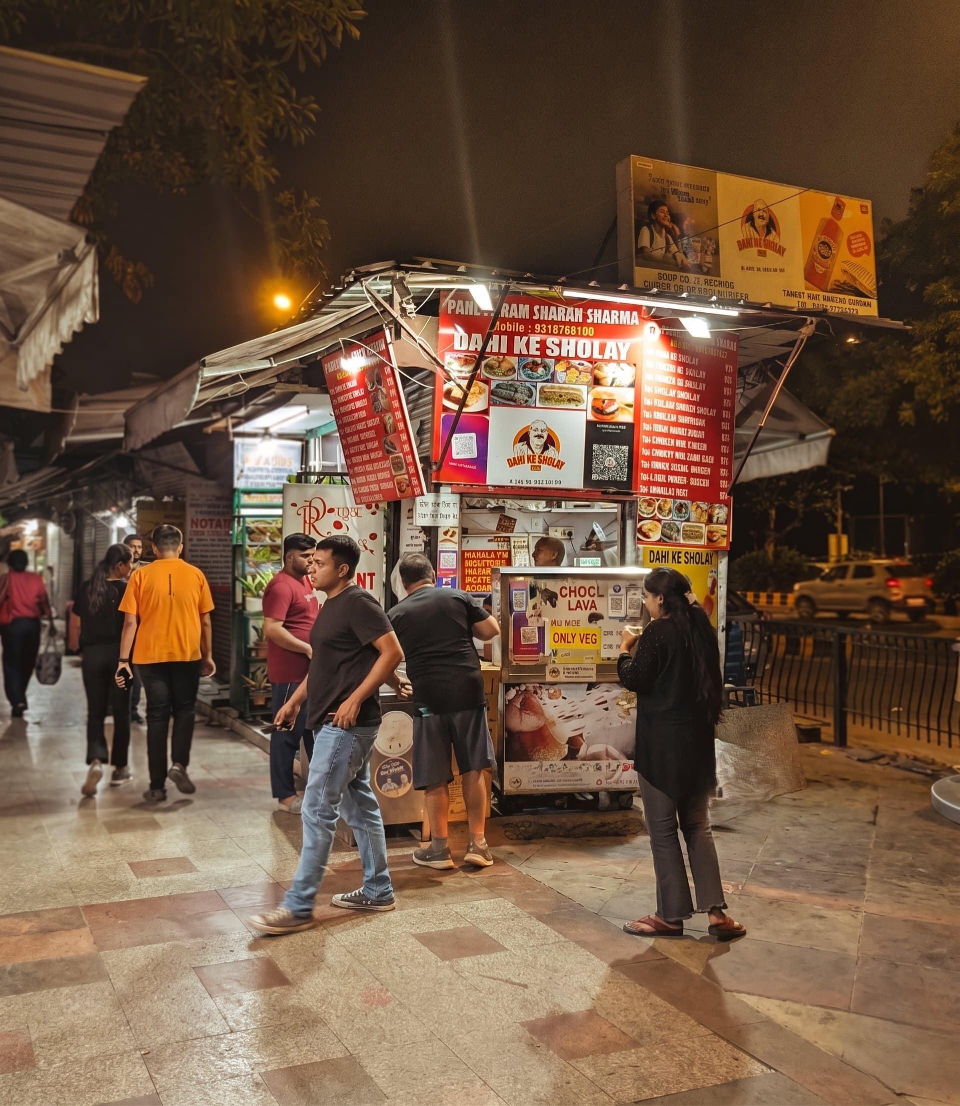 Dahi Ke Sholay shop at INA Market, Delhi, at night with customers